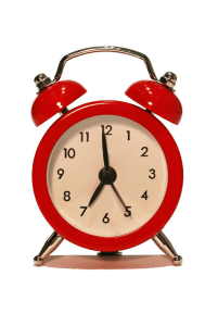 A red vintage alarm clock with a white face and black hands, showing the time as 10:10.